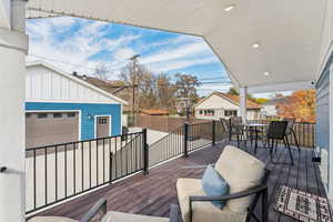 Covered back deck with dining space and gas line for a grill or fire pit, RV parking, garage, and bedroom/office