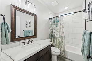 Hall main floor bathroom featuring vanity and shower / tub combo