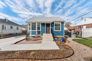 Charming Sugar House bungalow with shingled roof, patio, and entry steps