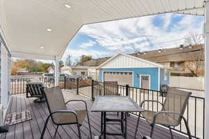 Covered back deck with dining space and gas line for a grill or fire pit, parking and 2-car garage with bonus bedroom/office