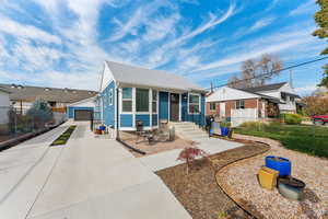 Bungalow-style home with 2-car garage, and partially xeriscaped yard