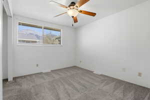 Spare room with light colored carpet and ceiling fan