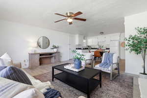 Living room featuring ceiling fan and wood finished floors