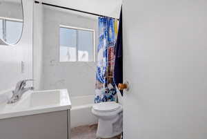 Bathroom with vanity and shower / tub combo