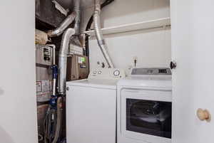 Laundry area featuring water heater and independent washer and dryer