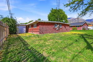Rear view of house featuring brick siding and a mountain view