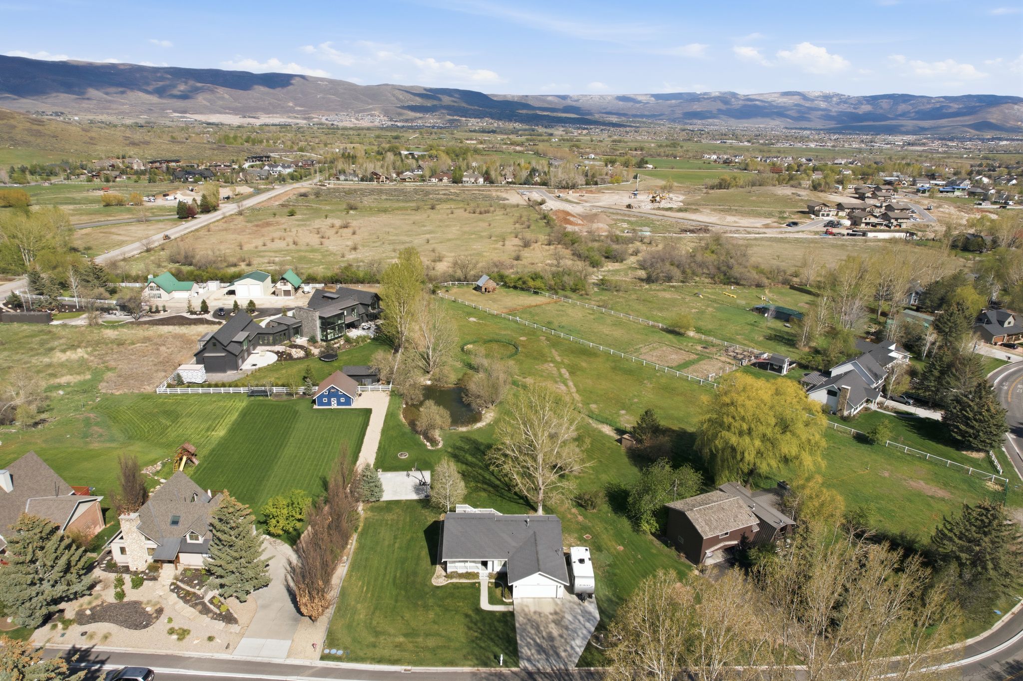 Aerial view of property's location with a mountainous background and rural landscape