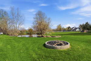 View of yard with an outdoor fire pit