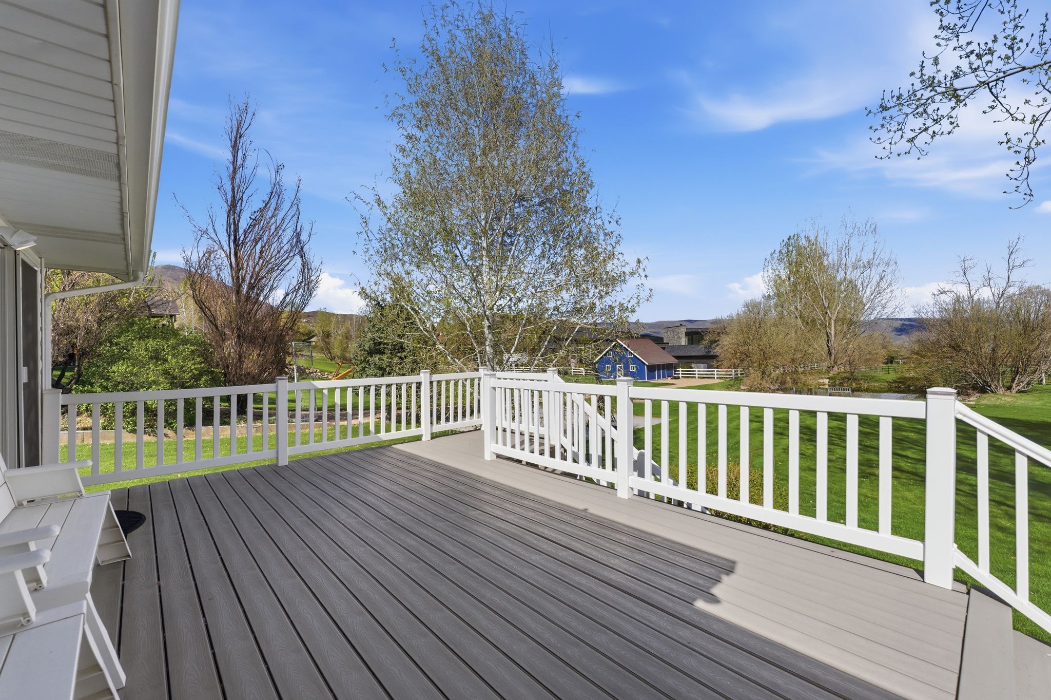 large deck off kitchen offers privacy and serenity