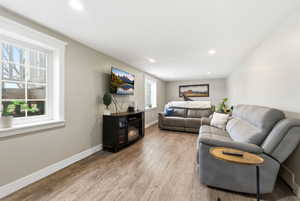 Living area featuring light wood-type flooring and recessed lighting