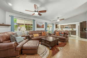 Living room with vaulted ceiling and ceiling fan