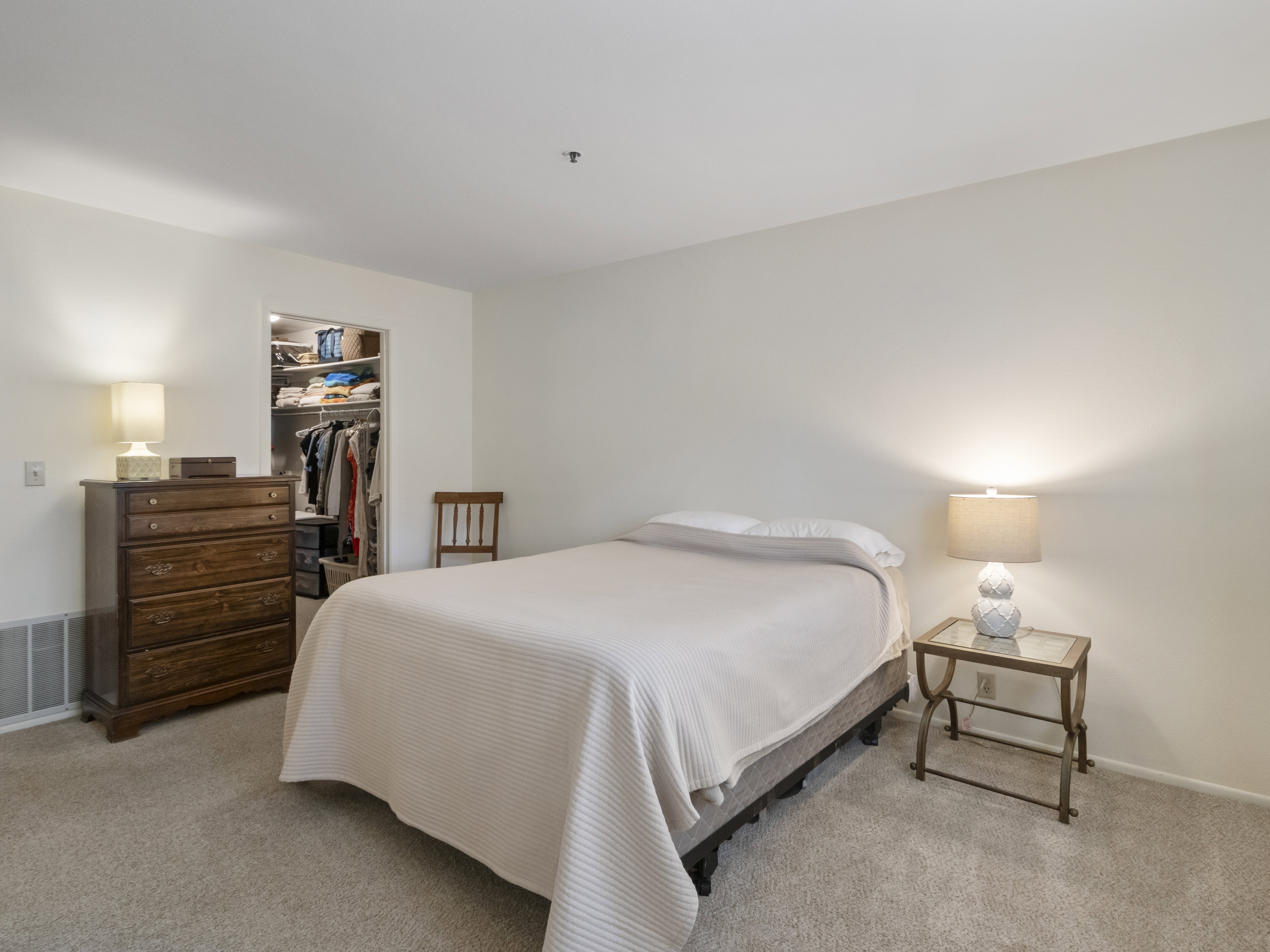 Bedroom featuring a walk in closet and light carpet