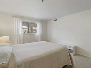 Bedroom featuring carpet flooring and baseboards