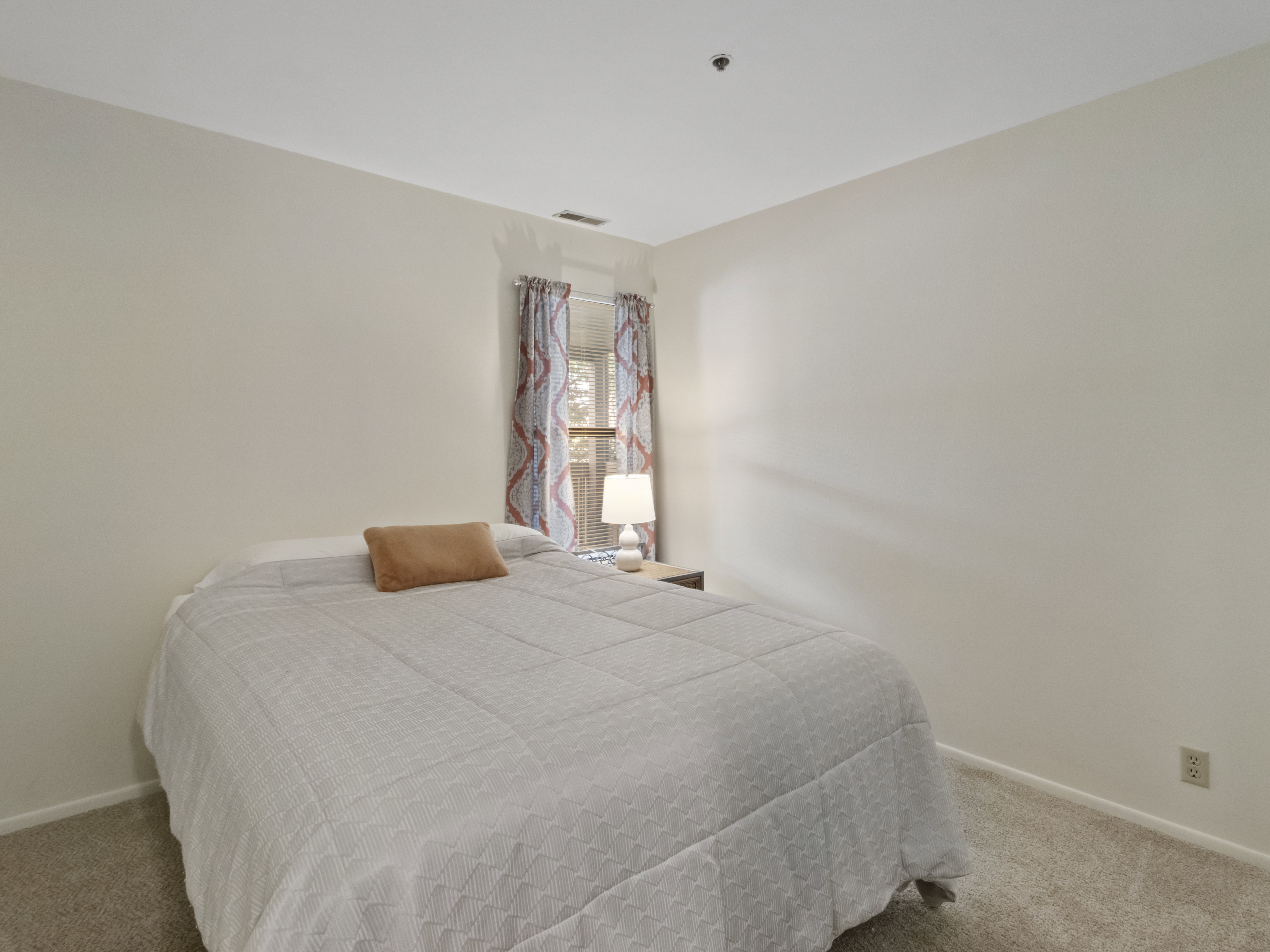Bedroom with light carpet