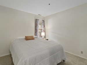 Bedroom with light carpet