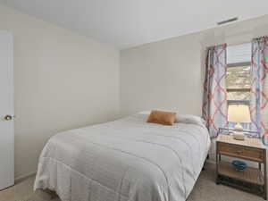 Bedroom with light colored carpet