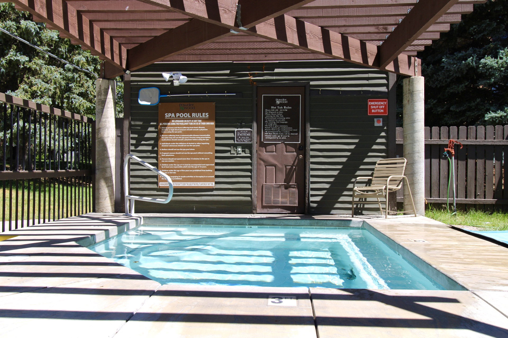 Outdoor spa with integrated steps and a surrounding concrete deck