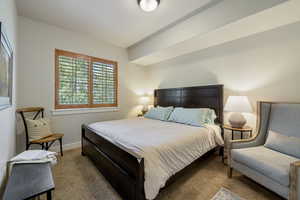 Bedroom featuring carpet floors and baseboards