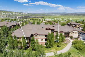 Aerial perspective of suburban area featuring mountains and property parcel outlined