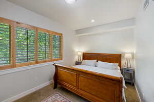 Carpeted bedroom featuring baseboards
