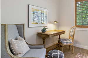 Living area with baseboards and carpet floors