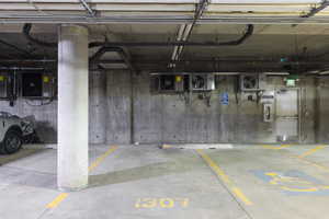 Garage featuring a parking garage and a heating unit