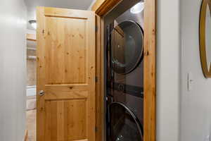 Laundry area featuring stacked washing machine and dryer