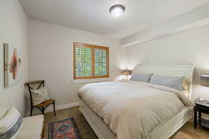 Bedroom featuring dark carpet and baseboards
