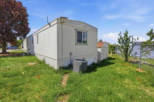 View of side of home featuring a central AC unit