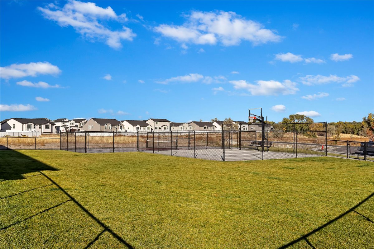 View of basketball court with a residential view and community basketball court