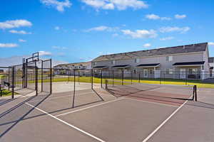 View of tennis court featuring community basketball court and a residential view