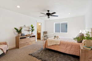 Carpeted bedroom featuring a ceiling fan, connected bathroom, and recessed lighting