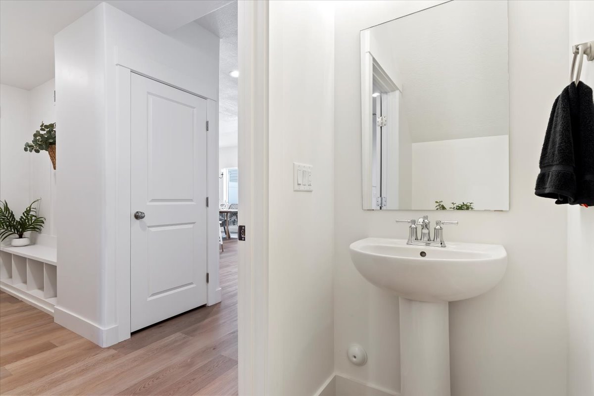 Bathroom featuring light wood-type flooring and baseboards