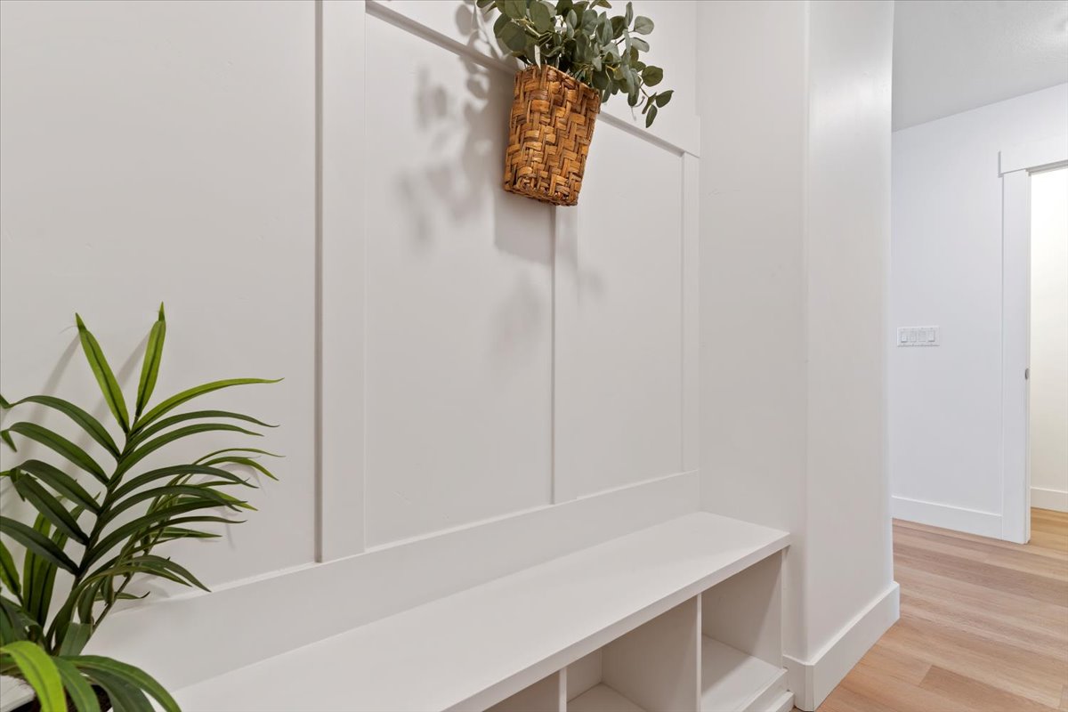Mudroom with light wood-type flooring and baseboards