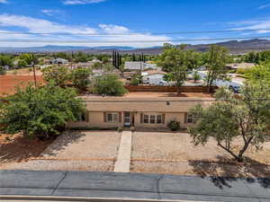 View of front of house with a residential view, a mountain view, and stucco siding