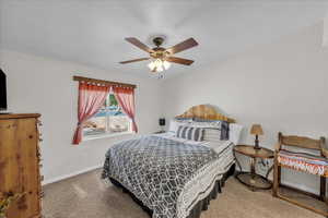 Bedroom with a ceiling fan and light carpet