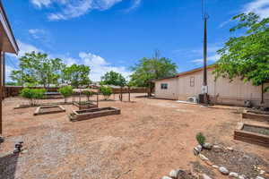Fenced backyard with a vegetable garden
