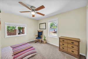 Bedroom featuring light carpet and ceiling fan