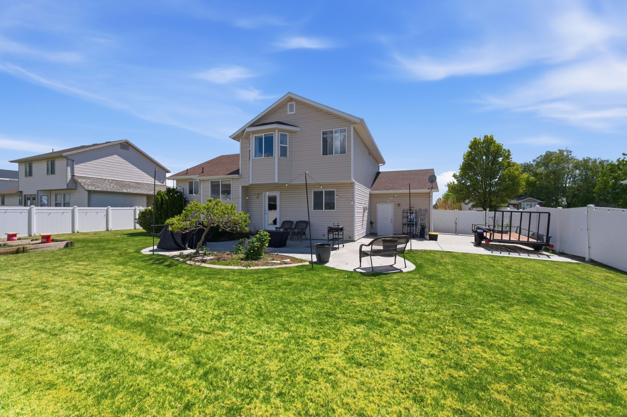 Rear view of house featuring a fenced backyard and a patio