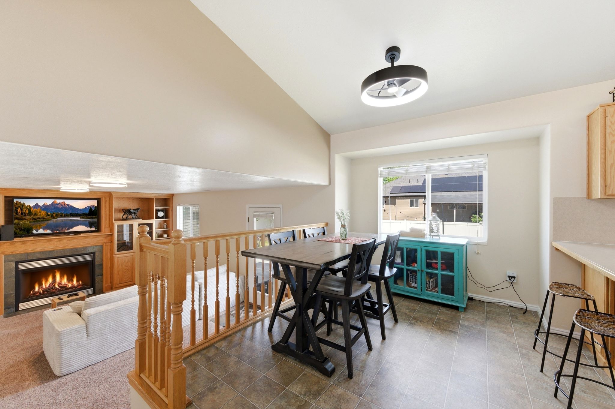 Dining room with lofted ceiling, a tile fireplace, and built in features