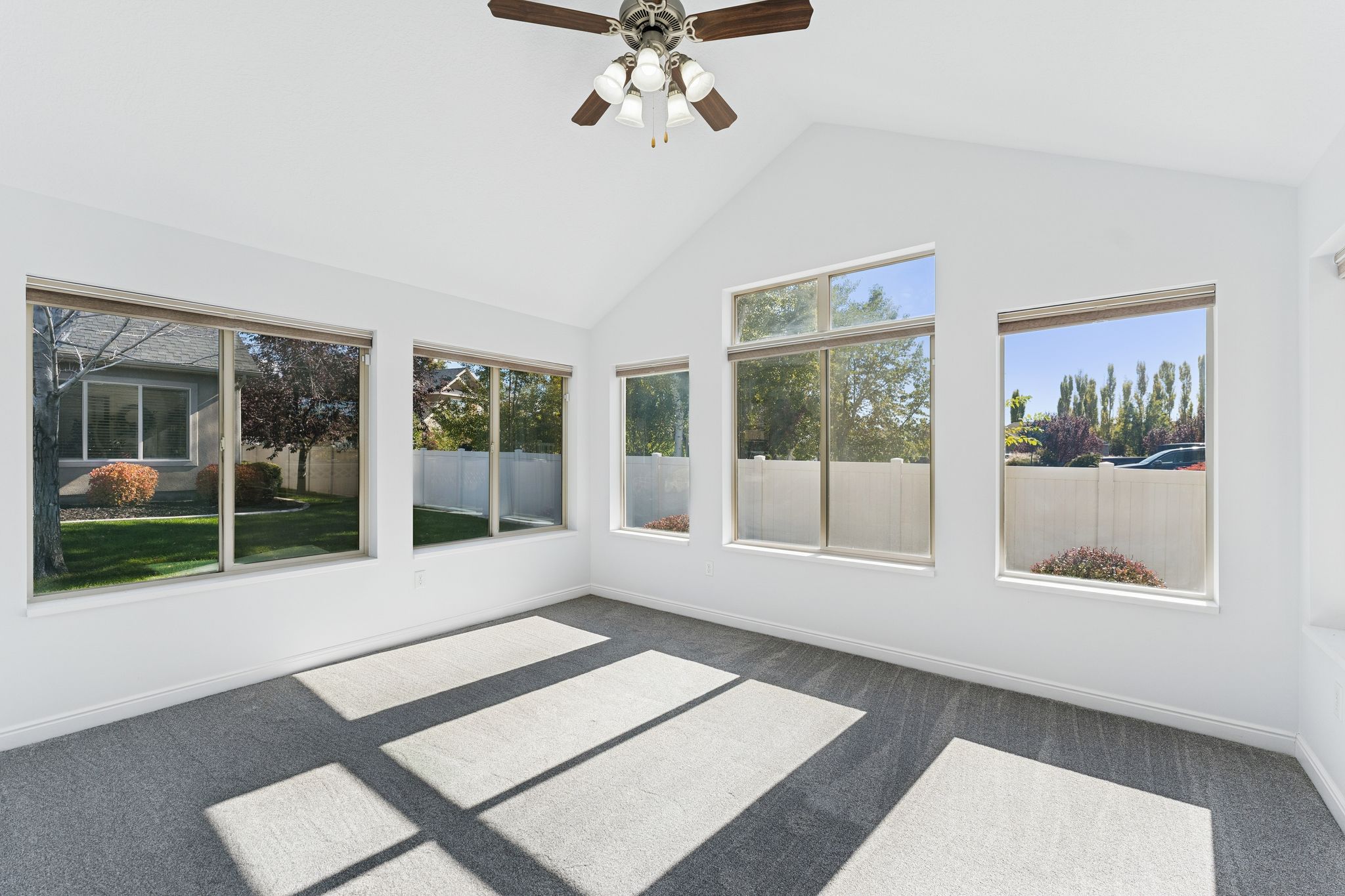 Unfurnished sunroom featuring baseboards and carpet