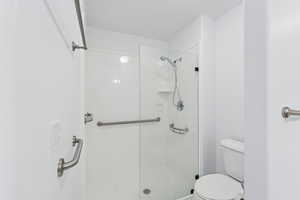 Full bath featuring a stall shower and a textured ceiling