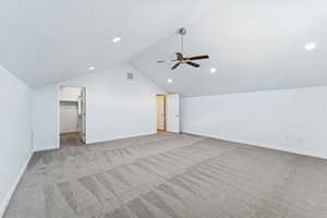 Bonus room featuring a ceiling fan, light carpet, and a textured ceiling