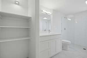 Full bathroom with a shower stall and vanity