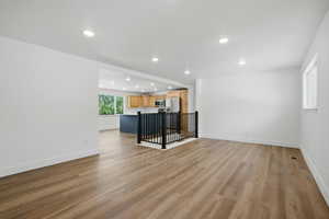 Unfurnished living room with light wood finished floors and recessed lighting