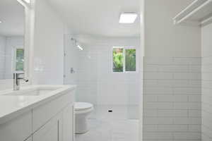 Full bath with vanity, tile walls, and a walk in shower