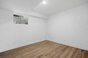 Unfurnished room featuring baseboards and wood finished floors
