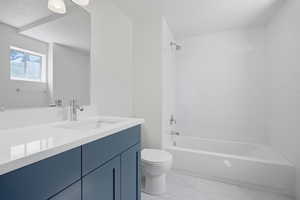 Bathroom featuring vanity, bathtub / shower combination, and light marble finish floors