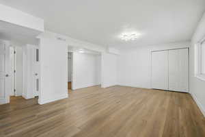 Unfurnished bedroom with light wood-type flooring and a closet