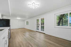 Unfurnished living room with french doors and light wood finished floors
